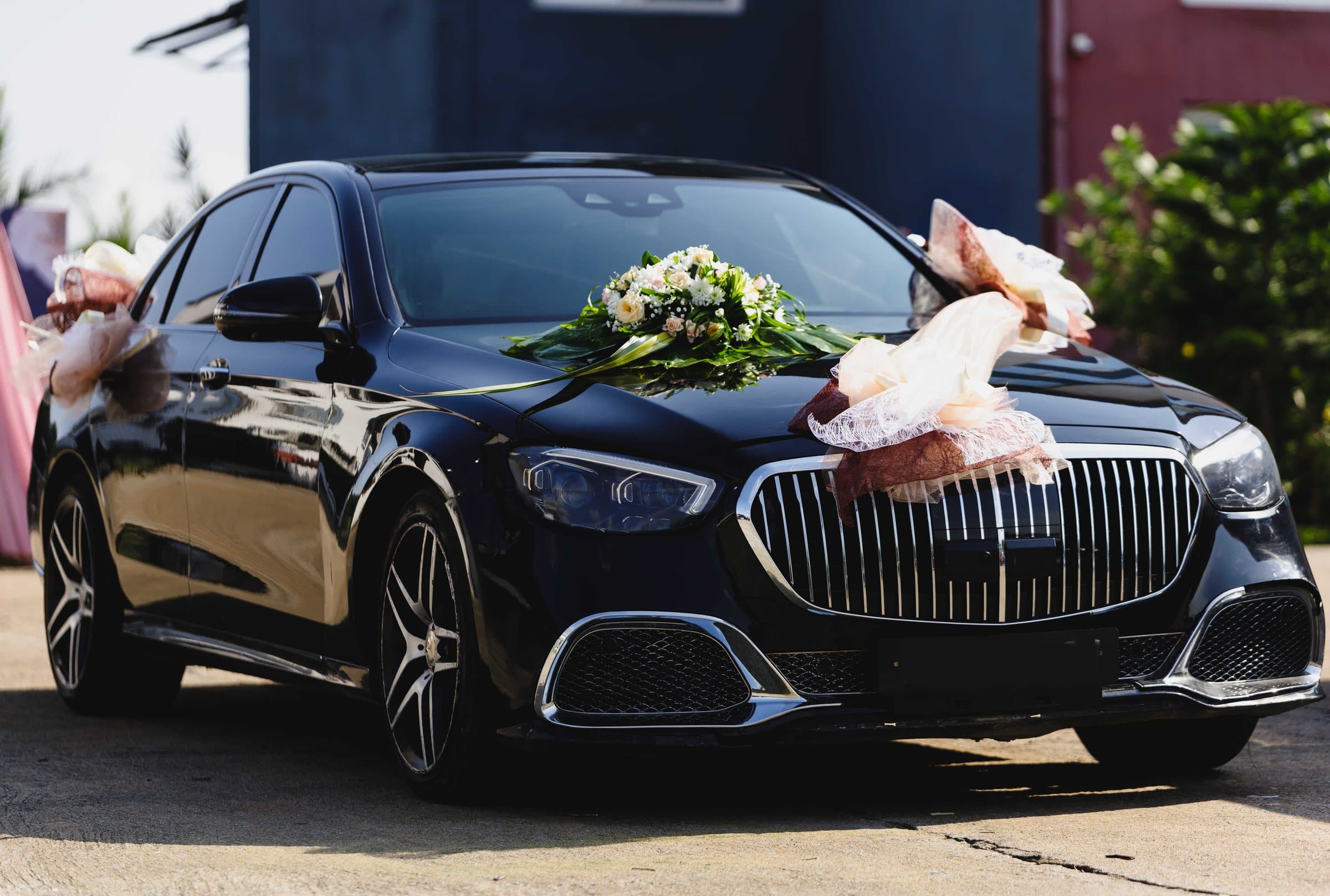 A black luxury saloon decorated with flowers and ribbon
