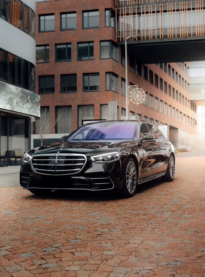 A black luxury saloon parked on a city street